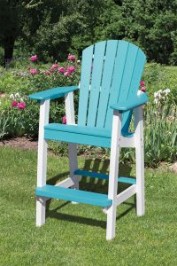 Aqua and white poly furniture balcony chair sitting in grass outside.