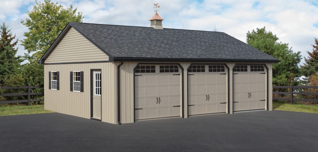 triple wide garage with tan siding, black trim, side door, two windows, and three garage doors with windows
