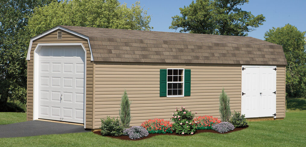 dutch barn garage with tan siding, white doors, green shutters